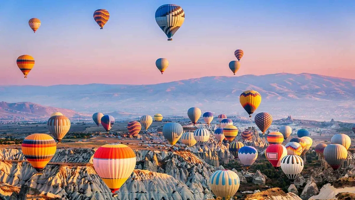 Hot air balloon baskets at dawn over the fairy chimneys of Göreme on a Cappadocia hot air balloon ride