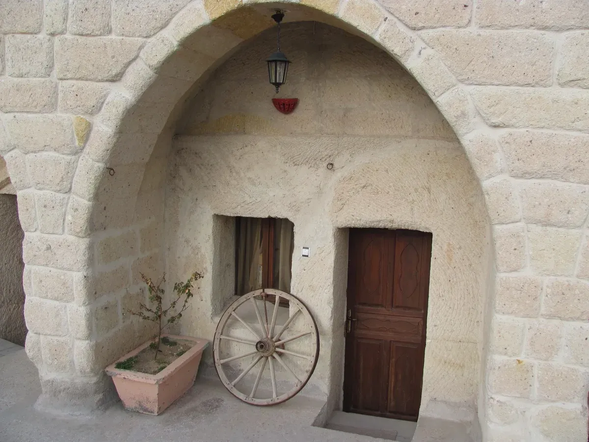 Arched entrance of a cave hotel room carved in tuff in Göreme, Cappadocia